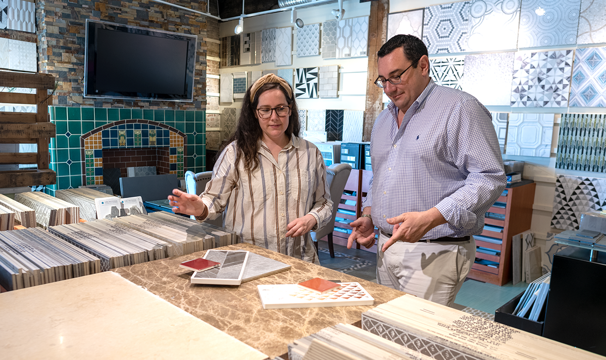 Two designers looking at tile in an Architessa showroom